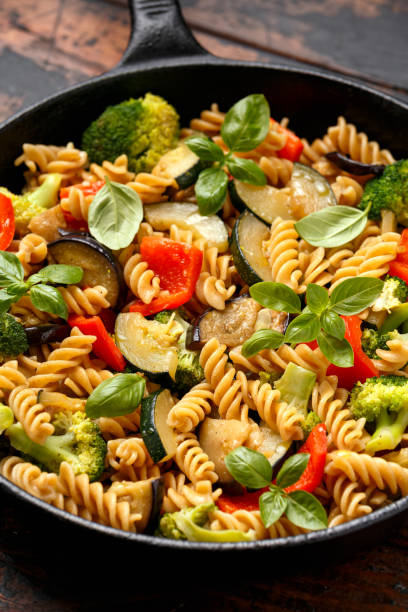 istock Fusilli pasta with vegetable, broccoli, zucchini, red pepper, eggplant and basil 1282125548