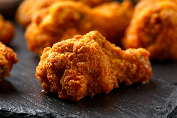 istock Spicy deep fried Chicken wings with ketchup on stone board 1282125584