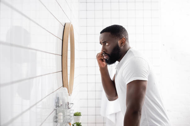 istock side view of afro-american man pulling lower eyelid with fingers 1282126948