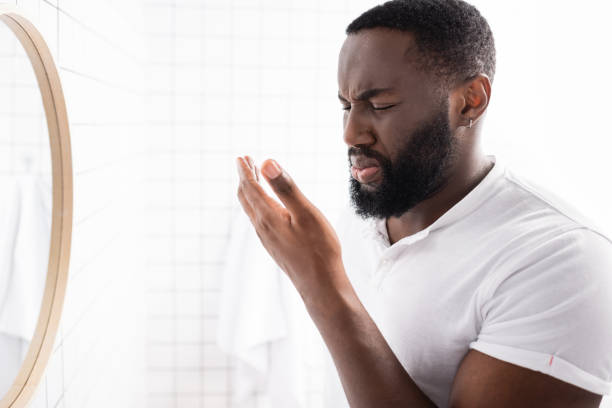 istock afro-american man breathing bad smell from mouth 1282126965