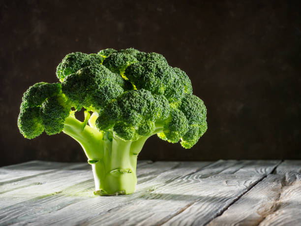 istock Fresh broccoli on wooden background. 1282128068