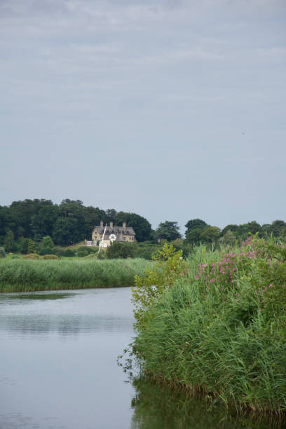istock Thatched house overlooking a reedy, peaceful river 1282128456