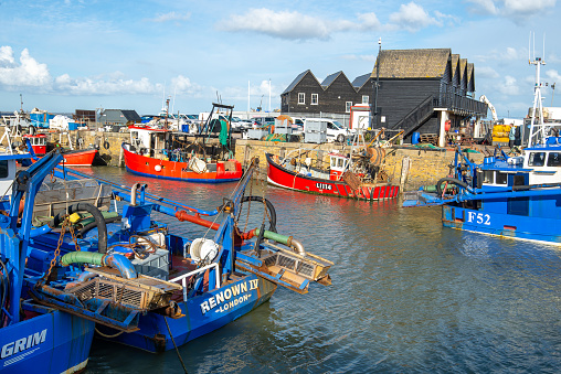 Whitstable Harbour, Kent, England - Oct 14 2020: Colourful fishing boats and trawlers on a bright, sunny, autumn morning at Whitstable Harbour on 14th October in Kent, England, UK.