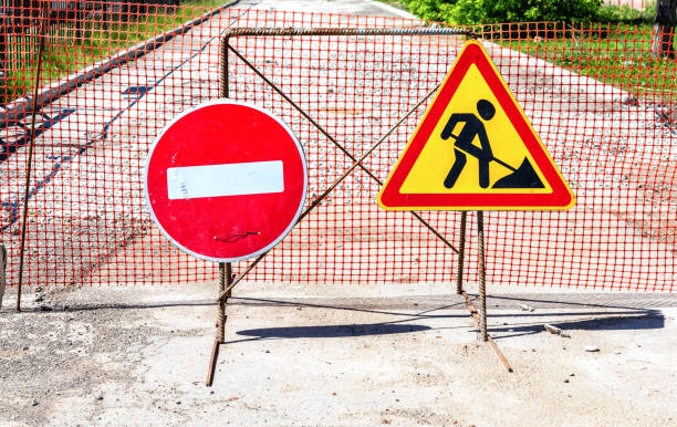 istock Under construction road sign on the closed road 1282129956