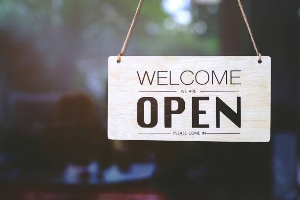 istock Coffee shop woman owner with face mask, open after lockdown quarantine. 1282129985