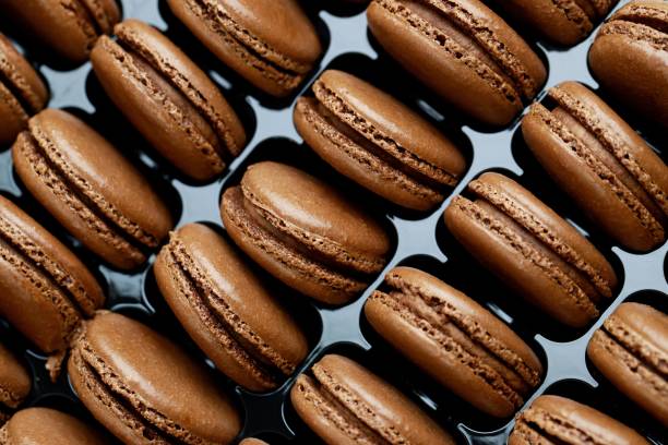 istock Chocolate-flavored French macarons are in the bakery. 1282130028