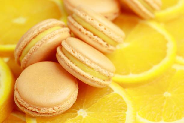 istock Orange flavored French macaroons are in the bakery. 1282130070