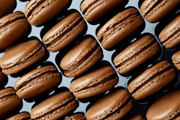 istock Chocolate-flavored French macaroons are in the bakery. 1282130160