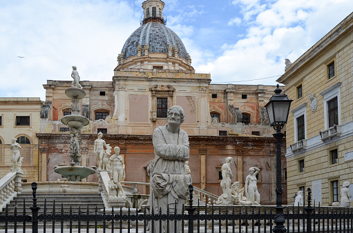 Palermo, Italy, March 27, 2013- The Praetoria Fountain with the dome of Santa Caterina in the background, in the square of Shame, Palermo, Italy