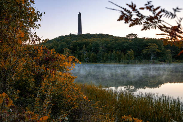 istock Tall obelisk monument on a mountain framed in fall foliage at sunrise. High Point State Park, NJ 1282130920