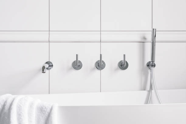 istock Bathtub faucet in white wall 1282131427