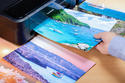 Man print and looking at photos for summer vacation. man planning travel vacation trip.