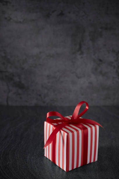 istock red gift box ribbon bow on grunge background and space for text 1282135912