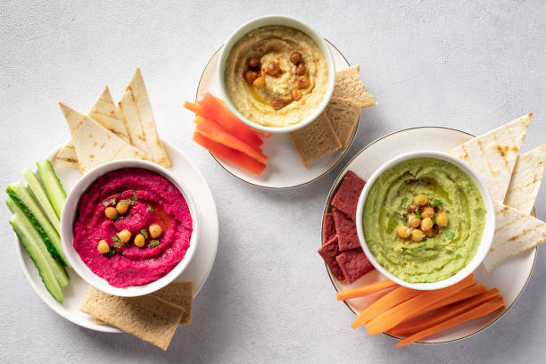 istock colorful hummus in bowls, served with vegetables sticks and crackers 1282138157