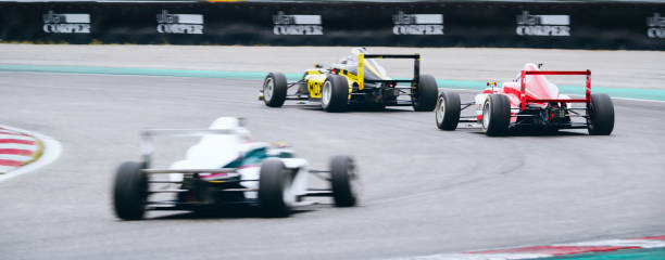 istock Drivers driving formula racing cars 1282139307