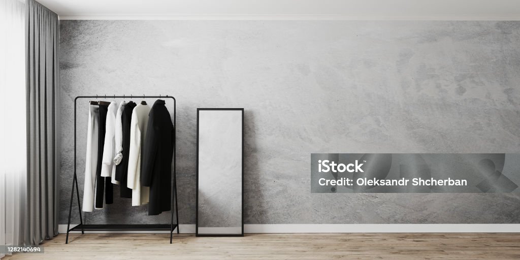 Clothes rack with floor mirror in black frame in room interior near window, gray wall and wooden floor, clothes stand, empty wall, 3d rendering Mirror - Object Stock Photo