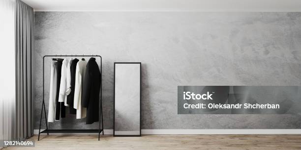 Clothes Rack With Floor Mirror In Black Frame In Room Interior Near Window Gray Wall And Wooden Floor Clothes Stand Empty Wall 3d Rendering Stock Photo - Download Image Now