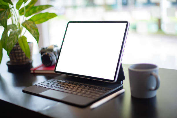 istock Desktop computer blank screen to insert pictures and text. On the table by the window 1282140939