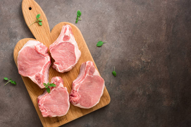 Raw pork steak. Pork meat pieces on a cutting board. Top view, flat lay. Raw pork steak. Pork meat pieces on a cutting board. Top view, flat lay pork stock pictures, royalty-free photos & images
