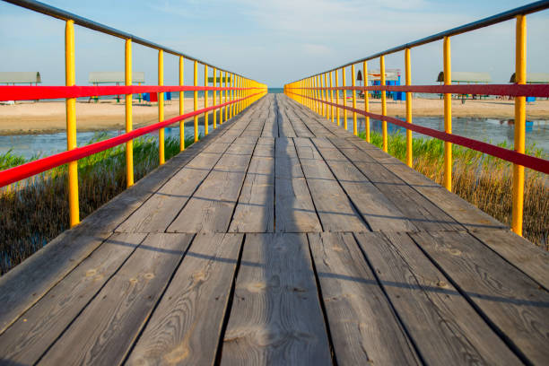 istock Wooden bridge at a beach on sunny day 1282142858