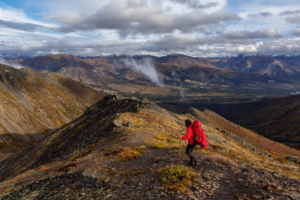 istock Woman Backpacking in Scenic Mountain Landscape 1282144380