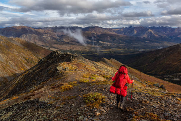 istock Woman Backpacking in Scenic Mountain Landscape 1282144389