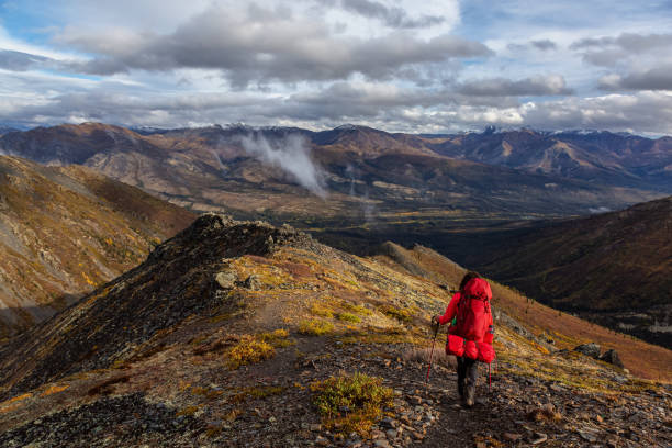 istock Woman Backpacking in Scenic Mountain Landscape 1282144408