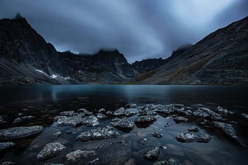 Beautiful Dramatic View of Rugged Mountains and Peaceful Alpine Lake at Twilight in Canadian Nature. Taken at Grizzly Lake in Tombstone Territorial Park, Yukon, Canada.