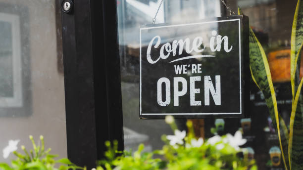istock Come in we're open, vintage black retro sign in store front 1282147693