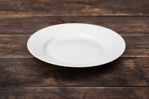 White empty plate on ristic wooden table