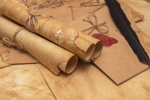 istock The surface of the old wooden table. On the table are old scrolls, an old map, an envelope with a seal, an iron key to the lock 1282149080