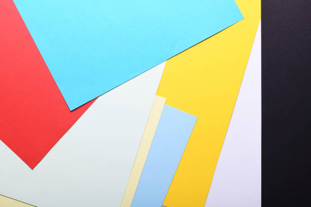 istock Multicolored paper background. Paper sheets of rainbow colors close-up. Geometric multitask background. Place for text. View from above.Close-up Of Multi Colored Paper. 1282149117