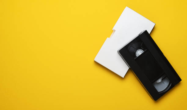 istock Old video cassette on a yellow background. Creative concept in retro style, 80s. Top view, minimalism. 1282150546