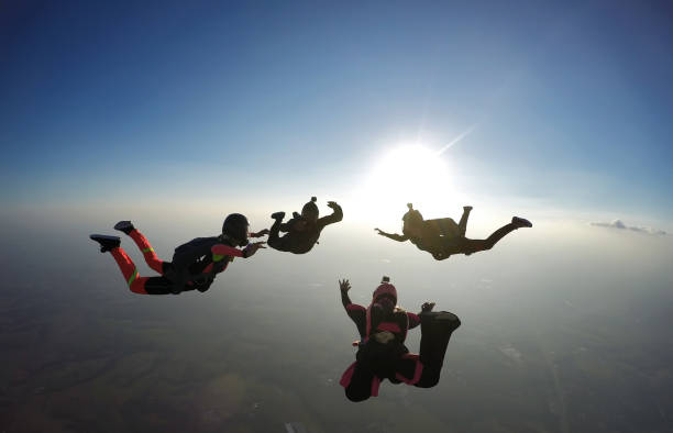 istock Skydiving group silhouette at the sunset 1282150747
