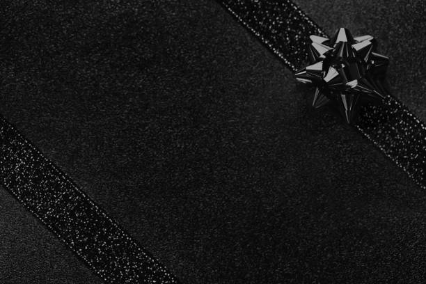 Black Friday Gift Box Holiday Background Glittering Ribbon Tied Bow Close-Up Directly Above Design template for presentation, flyer, card, poster, brochure, banner