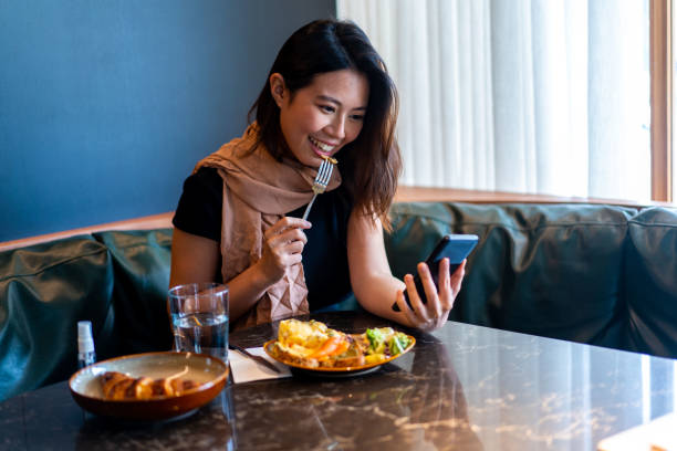 istock Beautiful Asian woman making a video call during a meal. 1282153280