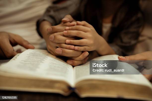 A Kid Reading The Holy Bible Stock Photo - Download Image Now - Praying, Bible, Church