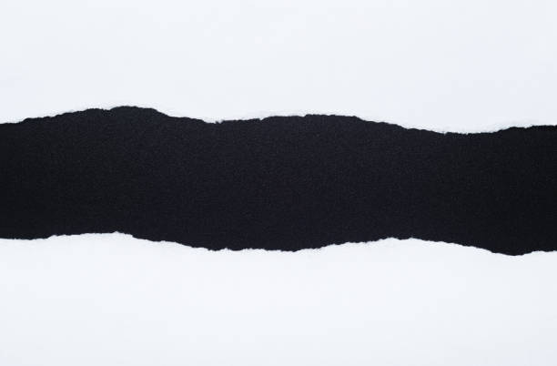 istock White paper with torn edges isolated with black colored paper background inside. Good paper texture 1282157163