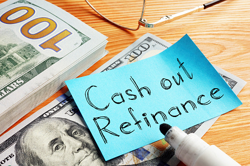 Cash out refinance is shown on a business photo using the text