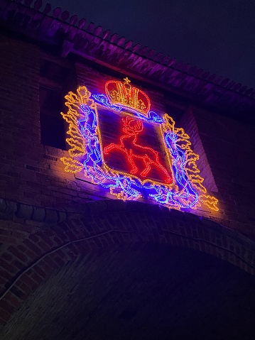 Coat of arms of Nizhny Novgorod City illuminated at night, located on the Kremlin wall, Russia