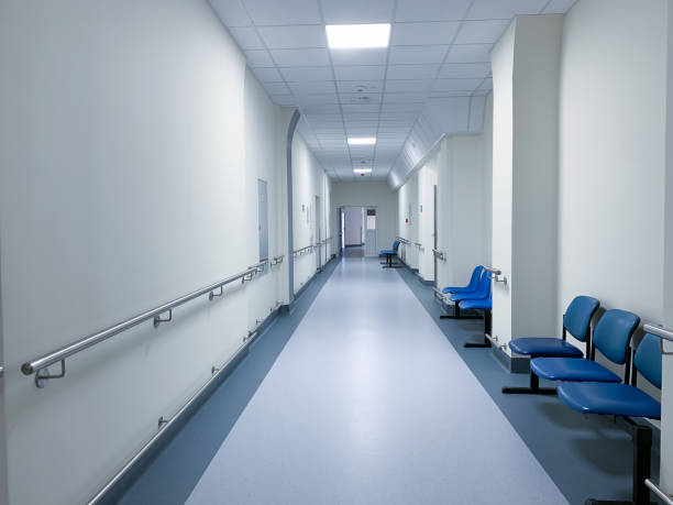 istock empty hospital corridor with medical beds and benches 1282159061
