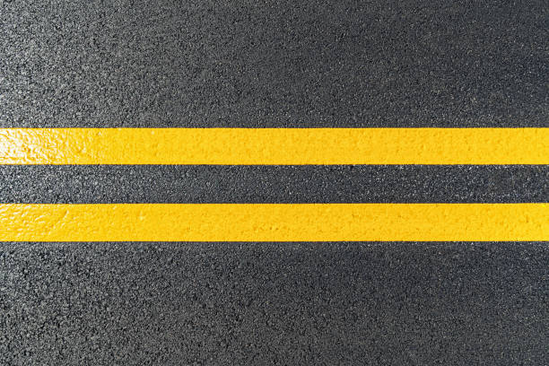 istock High angle view of a freshly painted double yellow lines on a newly paved road 1282160621