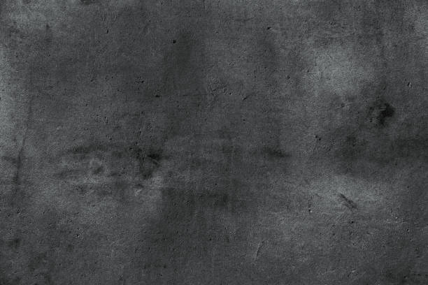 istock Dark gray cement wall with light spots as a background for decoration and text 1282160781