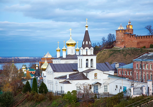 Autumn view of Orthodox Church with domes and spires and the a Kremlin in evening light in the Russian town of Nizhny Novgorod
