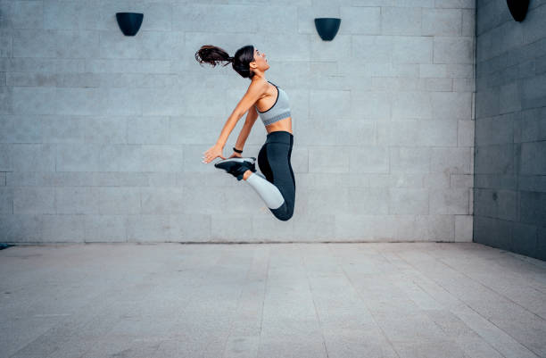 istock Woman athlete jumping during exercising 1282163736
