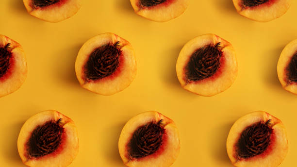 istock Ripe beautiful peaches with bones divided in half stacked in a row 1282165819