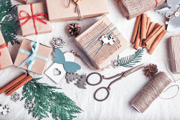 istock Christmas gifts on white crumpled fabric. Ecological packaging. Zero waste holidays. 1282167490