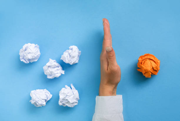 istock Creative new idea, Innovation, brainstorming, Inspiration, solution concept. Group Crumpled pieces of Paper. Not like everyone else. orange one is the first place, leadership, 1282168391
