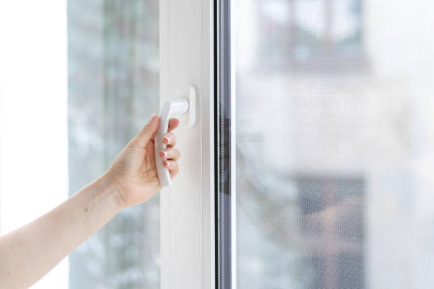 istock Woman closing pvc window with double glazing 1282169001