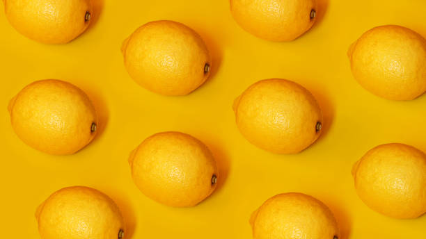 istock Food pattern with lemons on yellow paper background. Top view. Summer concept 1282169074
